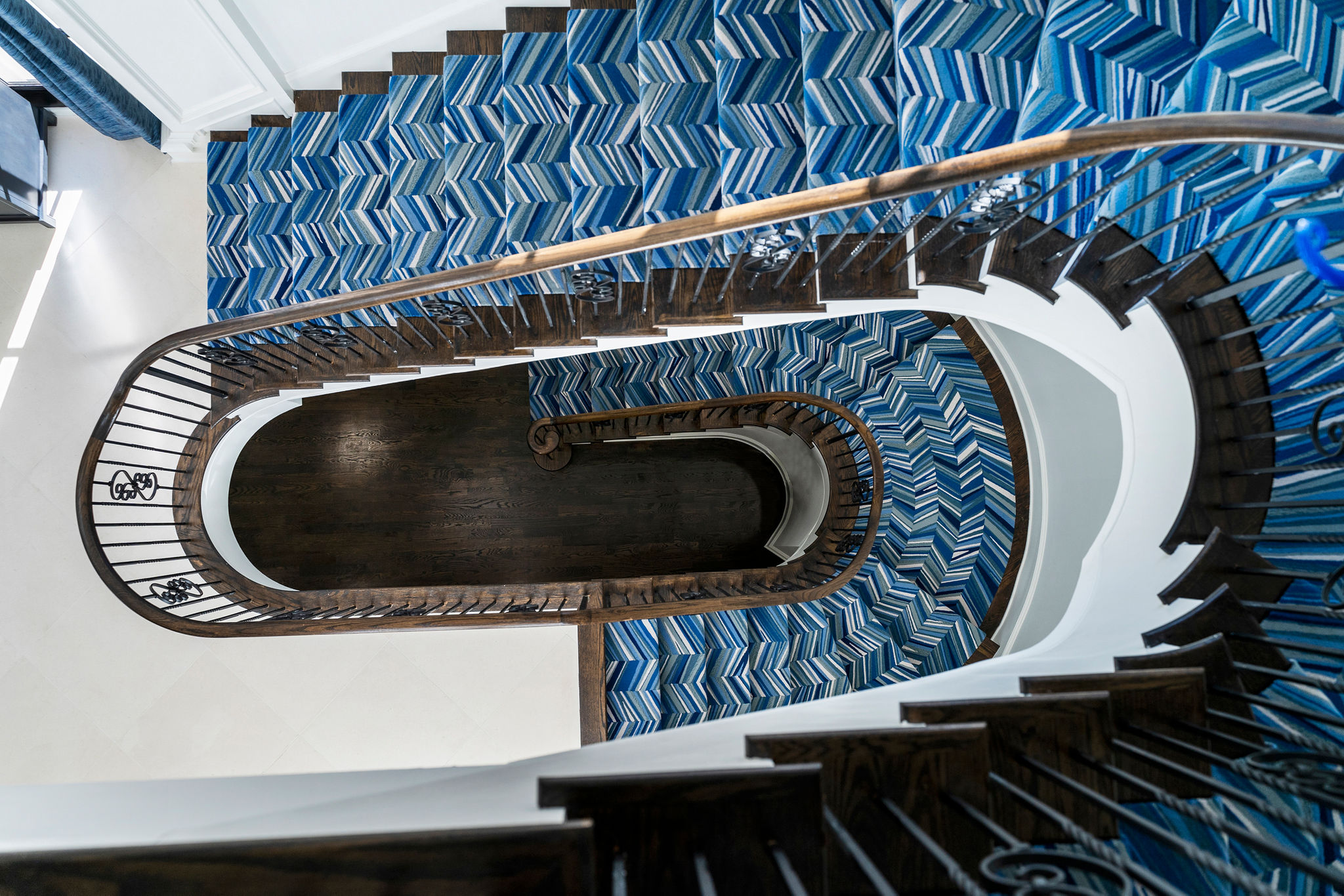 Curved staircase in a custom home by Vision Luxury Residential