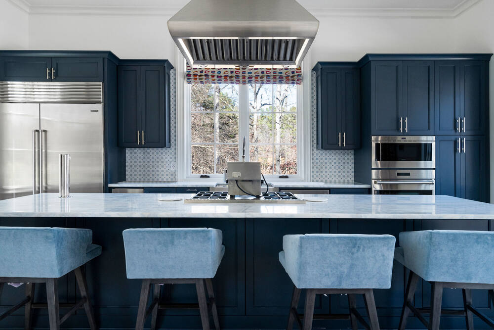 Blue custom kitchen renovation by Vision Luxury Residential with brass details